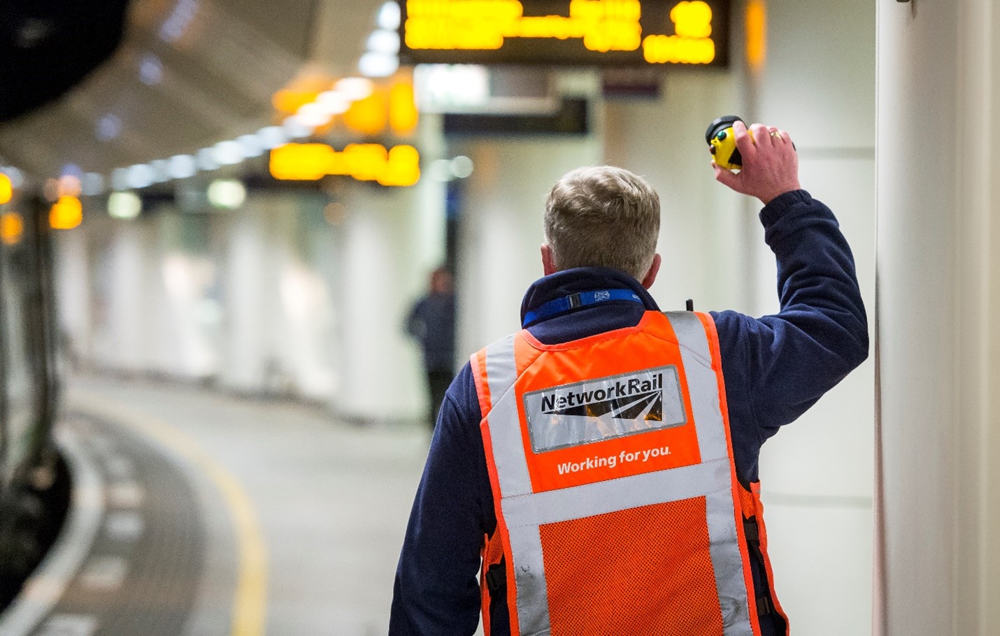 Member of staff dispatching train.