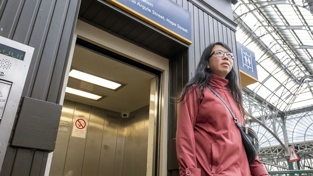 Passenger walking out of a lift in a station. 