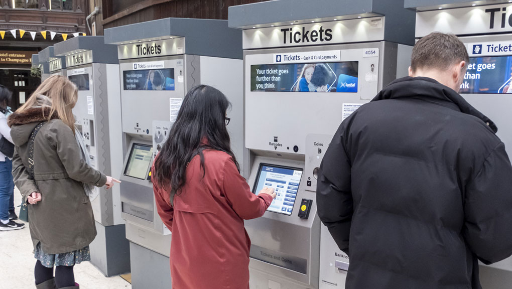 People buying tickets in a station