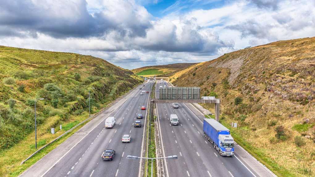 M62 motorway junction 22 looking west towards Rochdale from the Saddleworth Moors Pennine Way Bridge