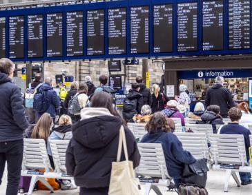 Passengers view Glasgow Central station departure boards